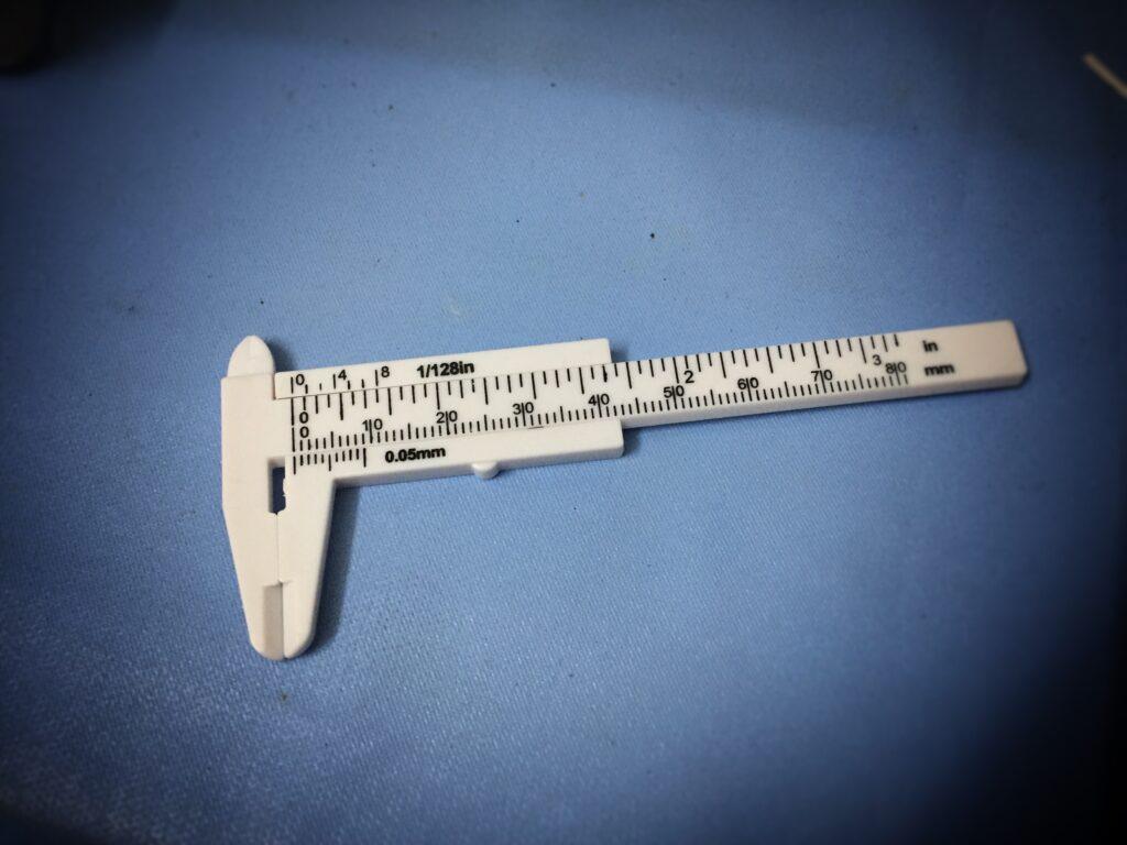 A vernier scale is a visual aid to take an accurate measurement reading between two graduation markings on a linear scale by using mechanical interpolation; thereby increasing resolution and reducing measurement uncertainty by using Vernier acuity to reduce human estimation error